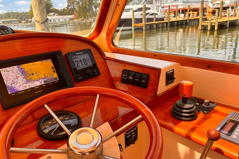 Slide: The Image of Helm of 1995 Hinckley Picnic Boat 36 Classic with navigation instruments and wooden steering wheel. - 24