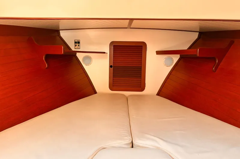 Slide: The Image of Interior cabin of 1995 Hinckley Picnic Boat 36 Classic with wooden finish and cushioned seating. - 30