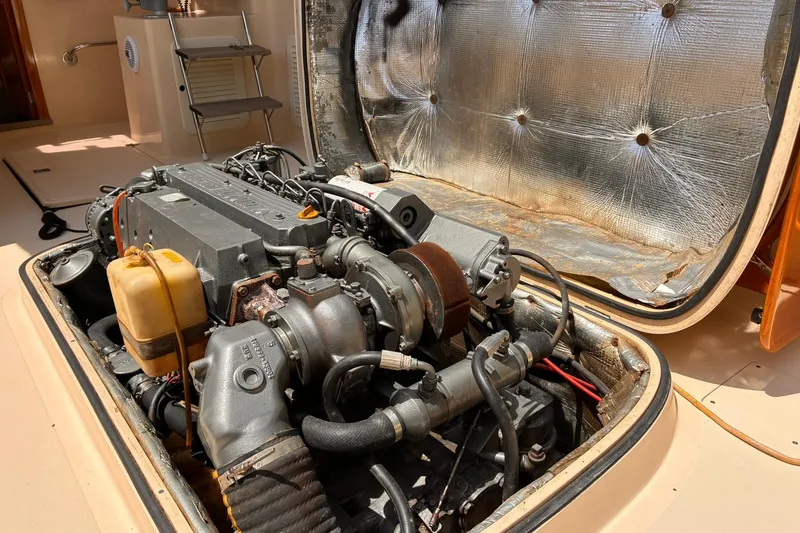 Slide: The Image of Engine compartment of a 1995 Hinckley Picnic Boat 36 Classic, showcasing detailed mechanical components. - 34