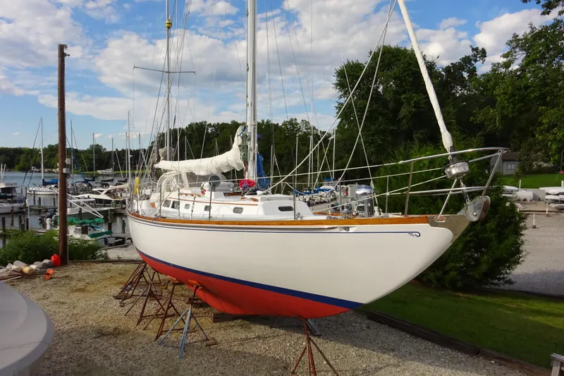 Slide: The Image of 1970 Hinckley Bermuda 40 Custom sailboat on stands in a marina setting. - 1