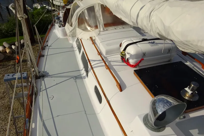 Slide: The Image of 1970 Hinckley Bermuda 40 Custom sailboat deck with lifeboat and rigging. - 11