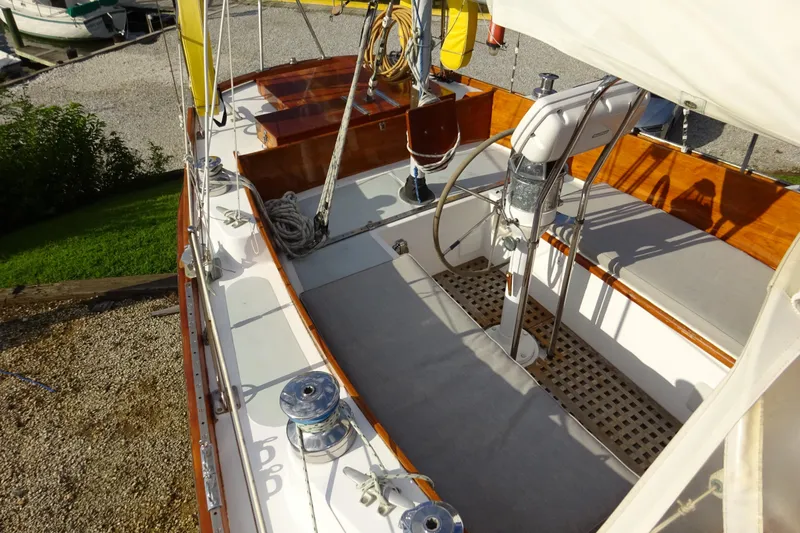 Slide: The Image of 1970 Hinckley Bermuda 40 Custom sailboat deck with wooden accents and steering wheel. - 13