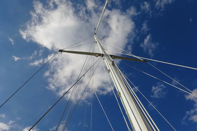 Slide: The Image of Mast of 1970 Hinckley Bermuda 40 Custom sailboat against blue sky with clouds. - 23