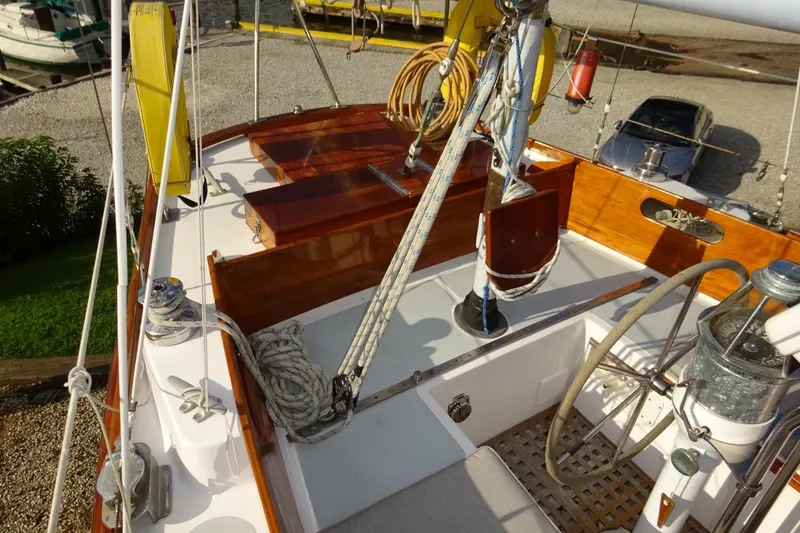 Slide: The Image of 1970 Hinckley Bermuda 40 Custom sailboat cockpit with wooden accents and nautical equipment. - 34