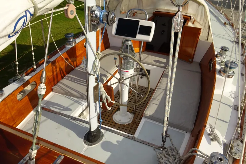 Slide: The Image of 1970 Hinckley Bermuda 40 Custom sailboat cockpit with wooden accents and navigation equipment. - 35