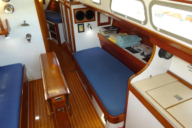 Slide: The Image of Interior of 1970 Hinckley Bermuda 40 Custom sailboat with wooden finishes and blue cushions. - 46