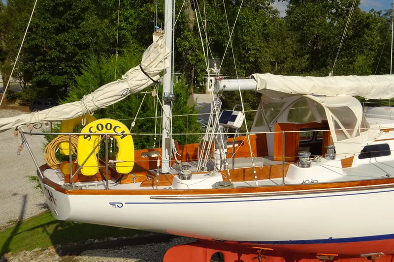 Slide: The Image of 1970 Hinckley Bermuda 40 Custom sailboat with yellow life ring, docked outdoors. - 6
