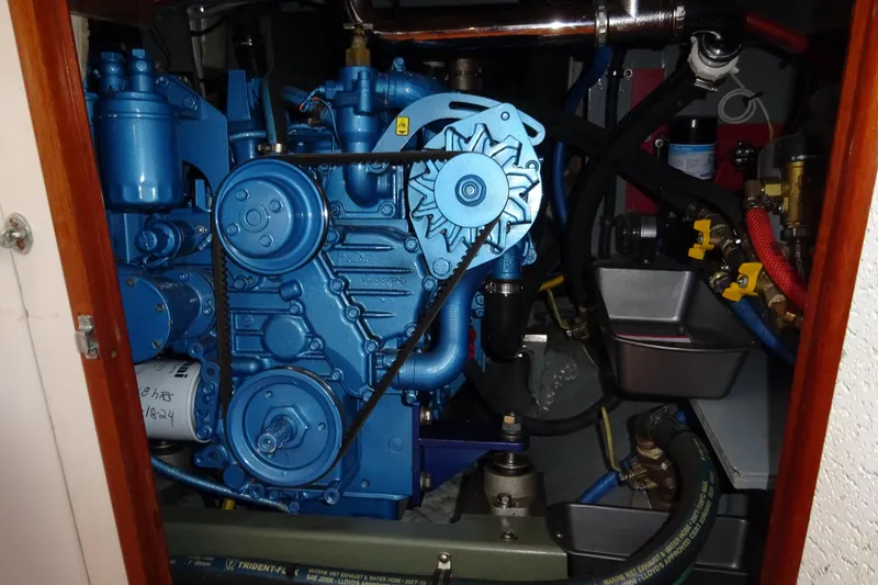 Slide: The Image of Engine compartment of a 1970 Hinckley Bermuda 40 Custom sailboat, featuring a blue engine. - 64