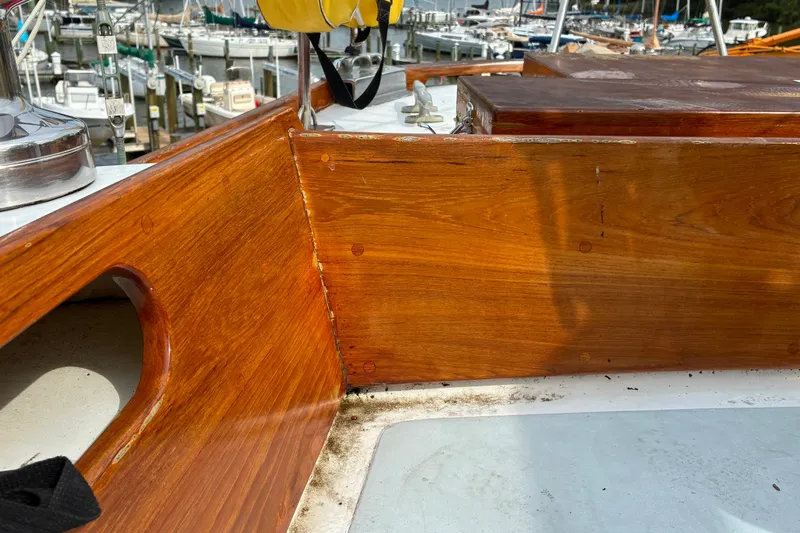 Slide: The Image of Hinckley Bermuda 40 sailboat, 1970 model, featuring polished wooden deck details at a marina. - 45