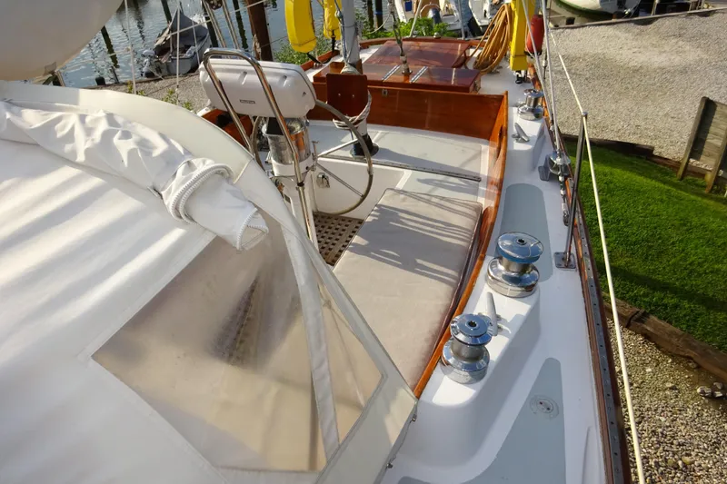 Slide: The Image of 1970 Hinckley Bermuda 40 Custom sailboat deck with winches and steering wheel. - 27
