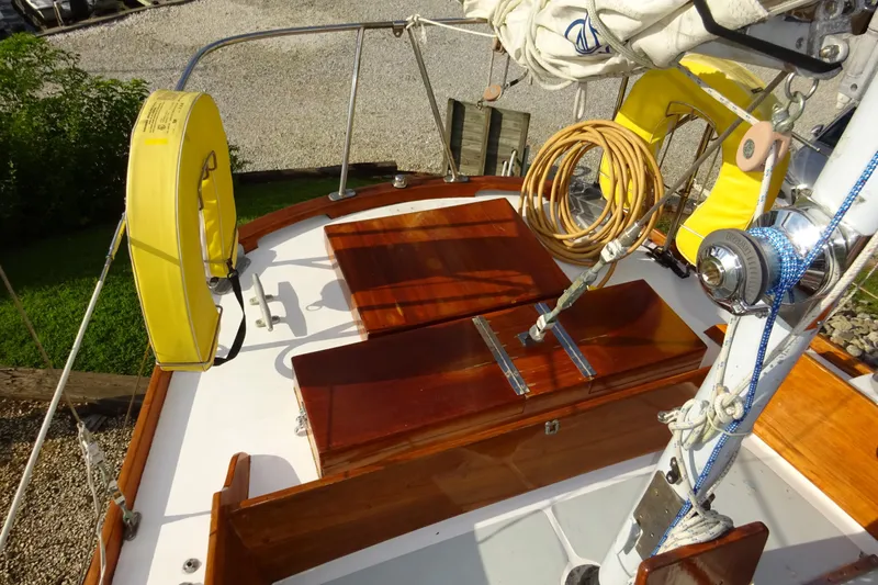 Slide: The Image of 1970 Hinckley Bermuda 40 Custom sailboat deck with yellow life rings and wooden hatch. - 32