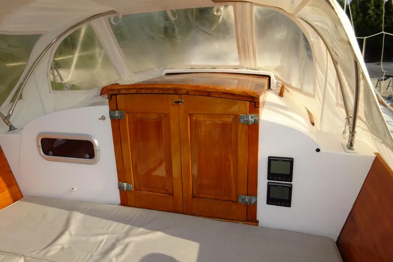 Slide: The Image of 1970 Hinckley Bermuda 40 Custom sailboat cockpit with wooden doors and navigation instruments. - 41