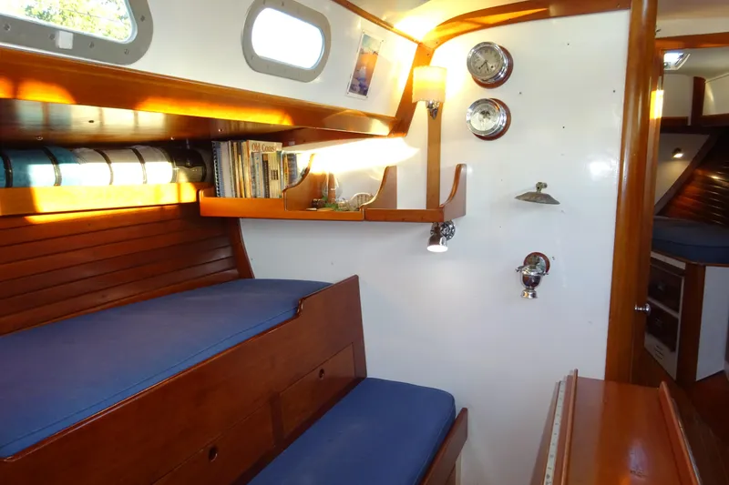 Slide: The Image of 1970 Hinckley Bermuda 40 Custom yacht interior with wooden finish and cozy seating area. - 48
