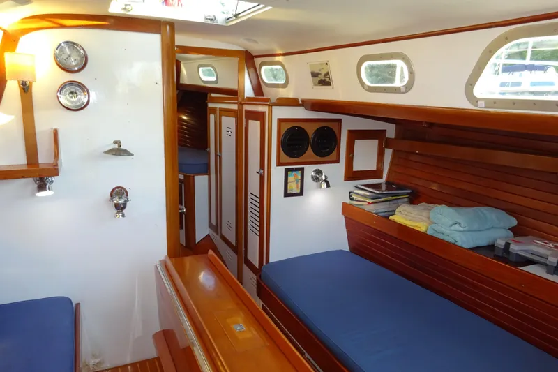 Slide: The Image of Interior of 1970 Hinckley Bermuda 40 Custom sailboat with wooden accents and cozy seating. - 49