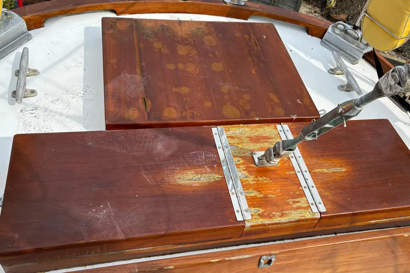Slide: The Image of Weathered wooden deck of a 1970 Hinckley Bermuda 40 sailboat, showing wear and metal fittings. - 43