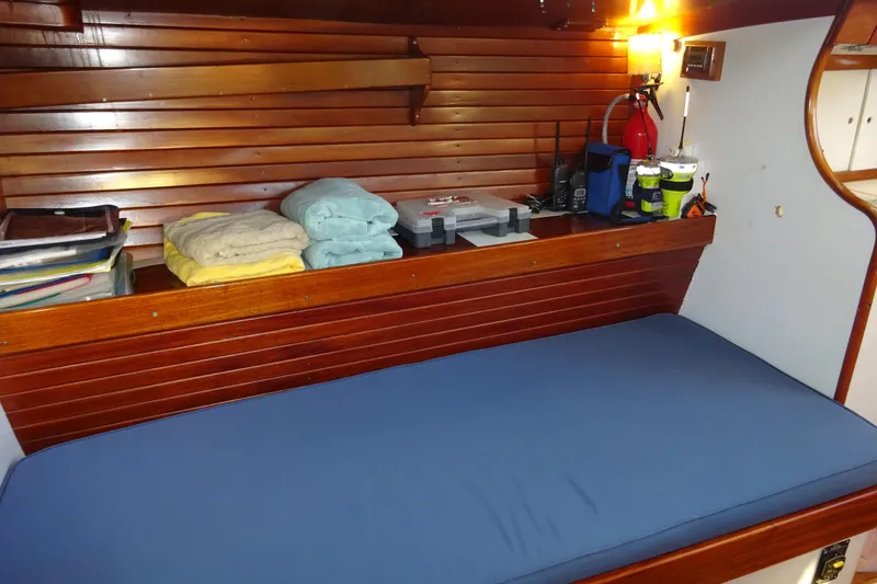 Slide: The Image of Interior of 1970 Hinckley Bermuda 40 Custom with wooden paneling and blue cushion. - 52