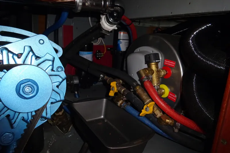 Slide: The Image of Engine compartment of 1970 Hinckley Bermuda 40 Custom with visible alternator and plumbing. - 66