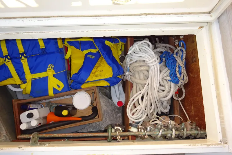 Slide: The Image of Storage compartment of 1970 Hinckley Bermuda 40 Custom with life jackets, ropes, and supplies. - 68