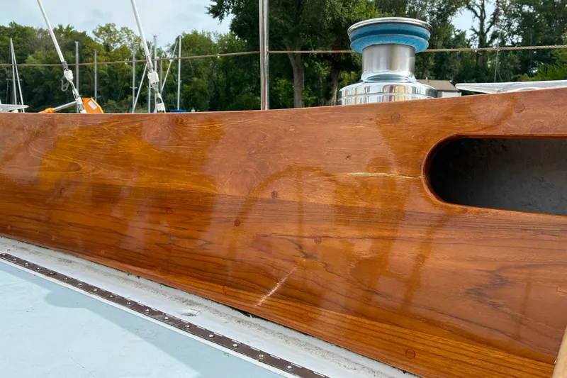 Slide: The Image of Polished wooden deck of a 1970 Hinckley Bermuda 40 sailboat with winch. - 46