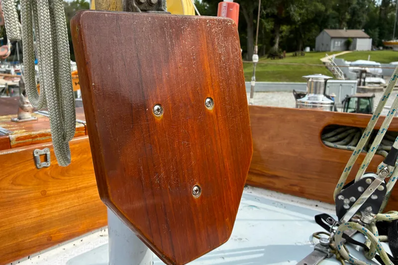 Slide: The Image of Wooden helm seat on a 1970 Hinckley Bermuda 40 sailboat deck, with ropes and fittings. - 37