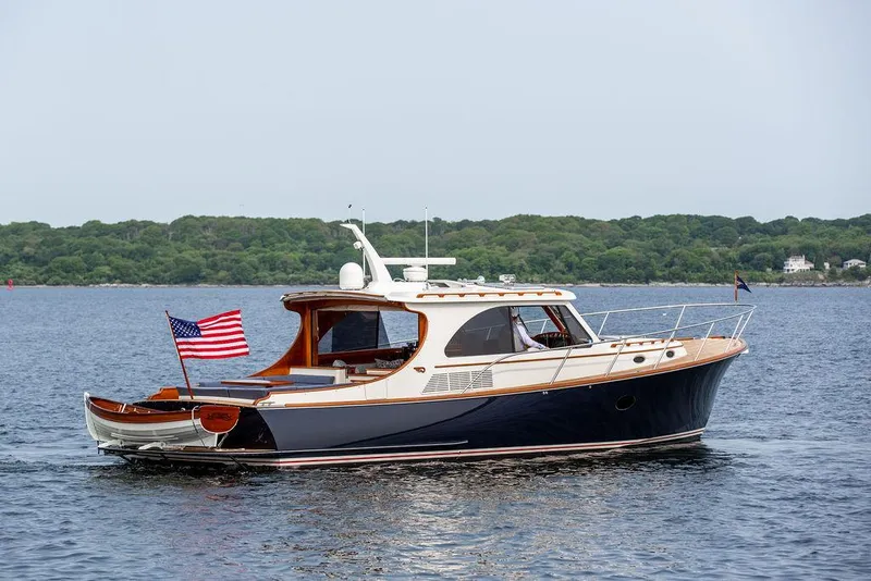 Slide: The Image of 2014 Hinckley Talaria 43 yacht cruising on calm waters with American flag. - 1