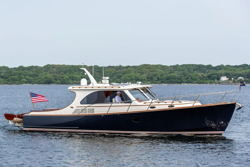 Slide: The Image of 2014 Hinckley Talaria 43 yacht cruising on calm waters. - 10