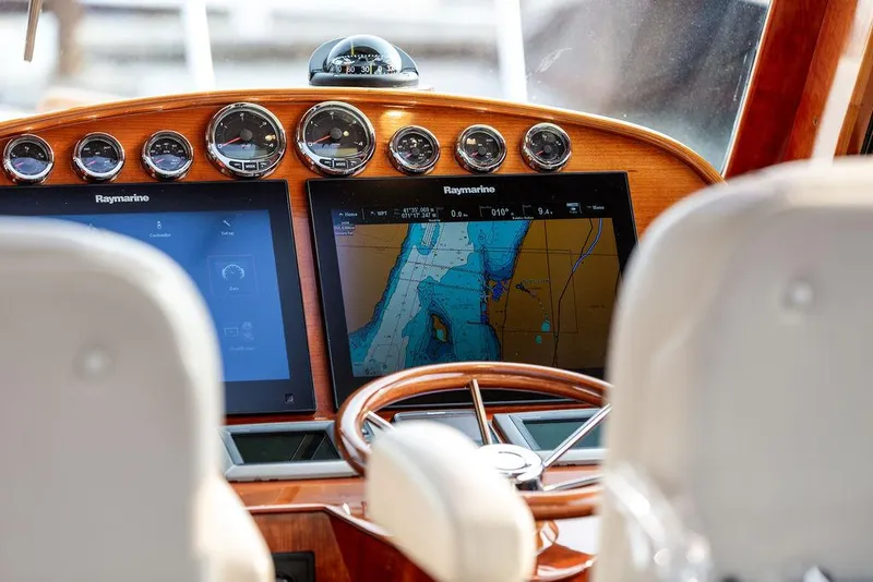 Slide: The Image of Helm of 2014 Hinckley Talaria 43 with navigation screens and gauges. - 12