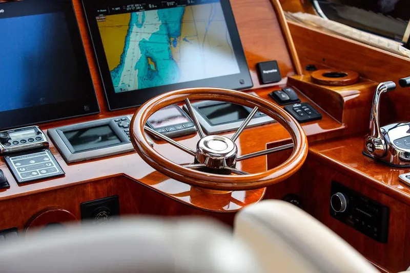 Slide: The Image of Steering wheel and navigation screens on 2014 Hinckley Talaria 43 yacht dashboard. - 14