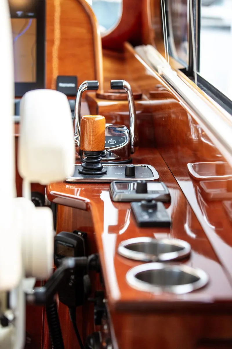 Slide: The Image of 2014 Hinckley Talaria 43 yacht helm with polished wood and modern controls. - 15