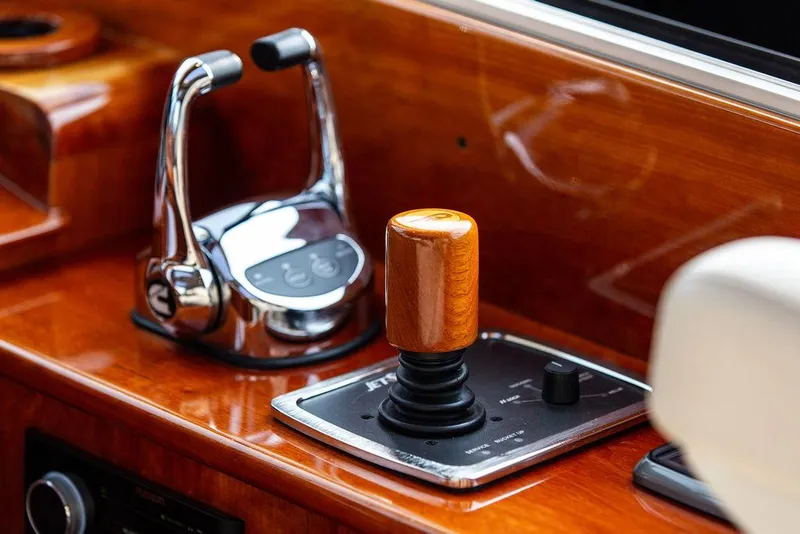 Slide: The Image of Hinckley Talaria 43, 2014 model, boat controls with wooden joystick and chrome throttle. - 16