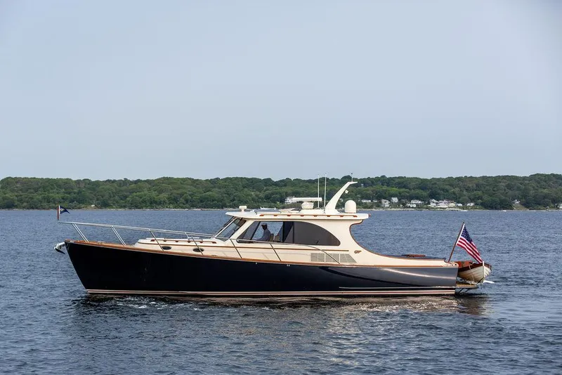 Slide: The Image of 2014 Hinckley Talaria 43 yacht cruising on calm waters. - 2