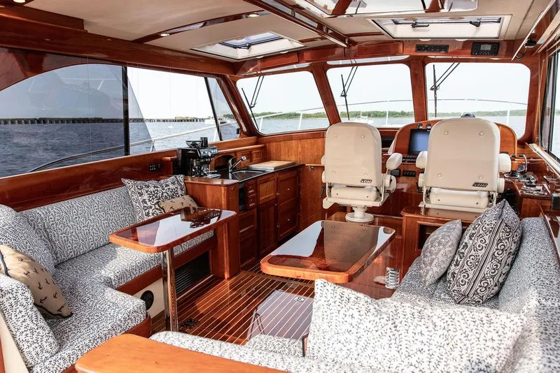 Slide: The Image of Luxurious interior of 2014 Hinckley Talaria 43 yacht with elegant wood finish and plush seating. - 25