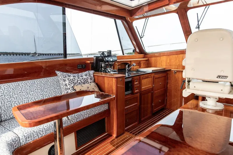 Slide: The Image of Luxurious interior of 2014 Hinckley Talaria 43 yacht with wood finish and seating area. - 26
