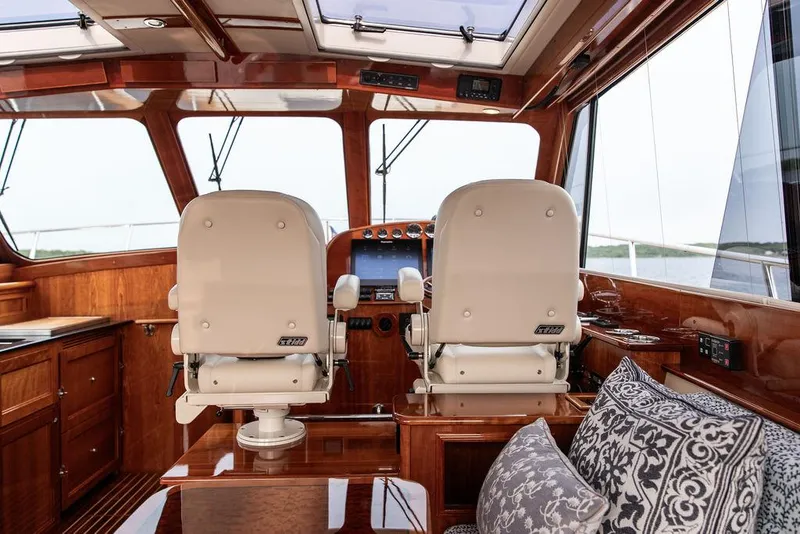Slide: The Image of Interior of 2014 Hinckley Talaria 43 yacht with elegant wood finish and helm seats. - 27