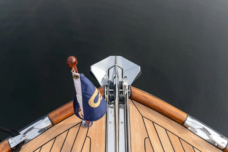 Slide: The Image of Bow of 2014 Hinckley Talaria 43 yacht with wooden deck and flag. - 29