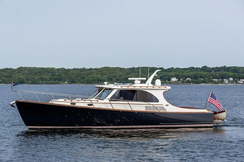 Slide: The Image of 2014 Hinckley Talaria 43 yacht cruising on calm waters with American flag. - 3
