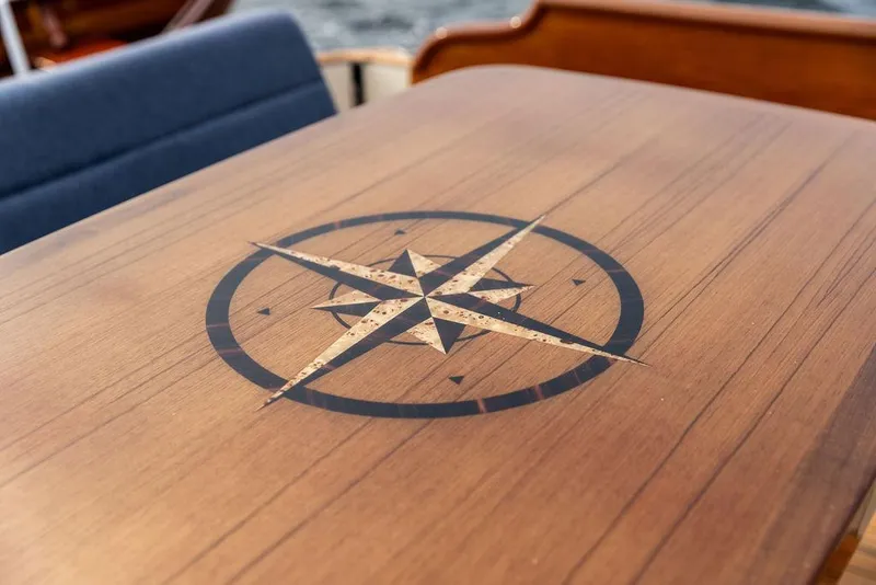 Slide: The Image of Wooden table with compass rose design on 2014 Hinckley Talaria 43 yacht. - 33