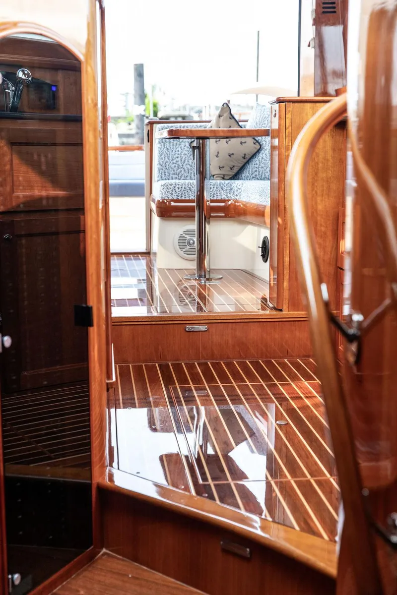 Slide: The Image of 2014 Hinckley Talaria 43 interior with polished wood finish and elegant design. - 34