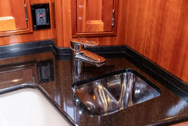 Slide: The Image of Luxurious kitchen sink area in 2014 Hinckley Talaria 43 yacht with sleek faucet design. - 38