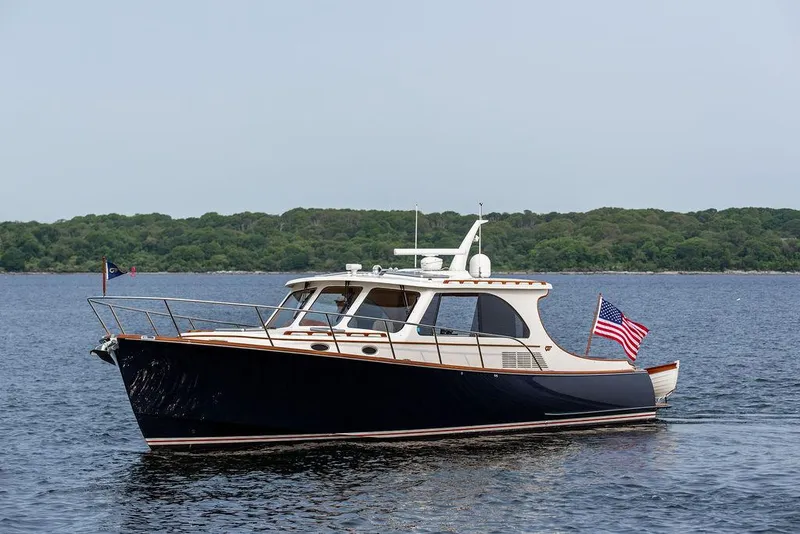 Slide: The Image of 2014 Hinckley Talaria 43 yacht on calm water with American flag. - 4