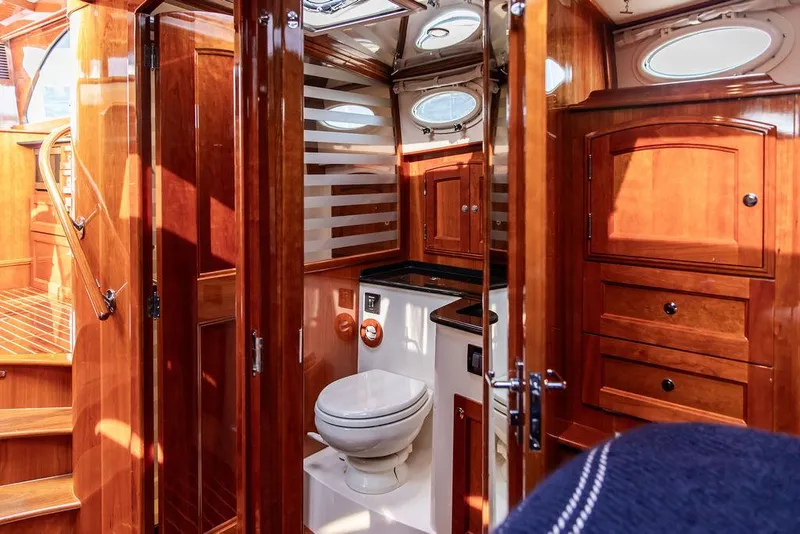Slide: The Image of Luxurious 2014 Hinckley Talaria 43 yacht bathroom with wooden cabinetry and modern fixtures. - 41