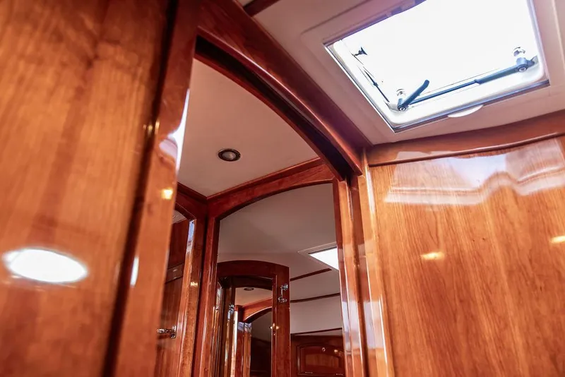 Slide: The Image of Interior view of 2014 Hinckley Talaria 43 yacht with polished wood finish and skylight. - 47