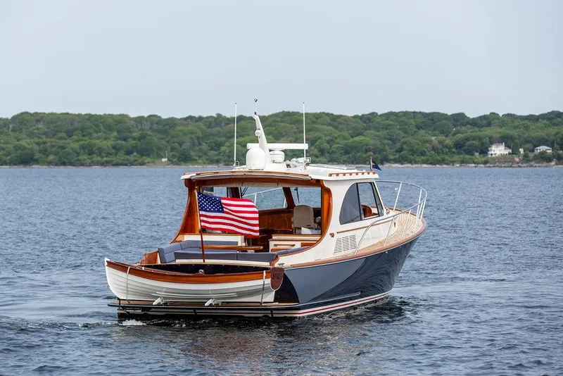 Slide: The Image of 2014 Hinckley Talaria 43 yacht cruising on calm waters with American flag. - 6