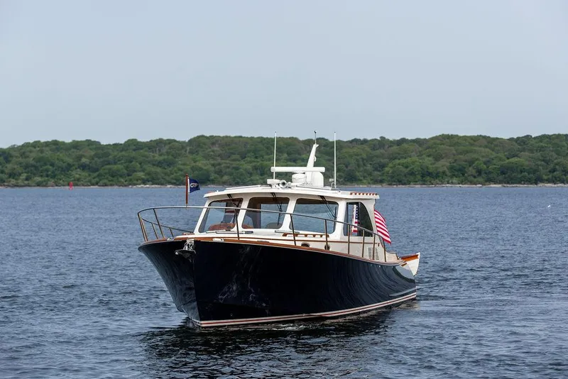 Slide: The Image of 2014 Hinckley Talaria 43 yacht cruising on calm waters. - 7