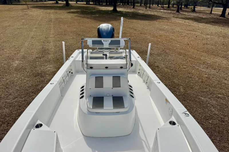 Slide: The Image of 2007 BlackJack 224 boat on dry land, showcasing sleek design and spacious deck. - 11