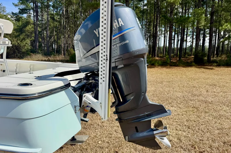 Slide: The Image of Boat with Yamaha outboard motor, BlackJack 224, 2007 model, in a forested area. - 3