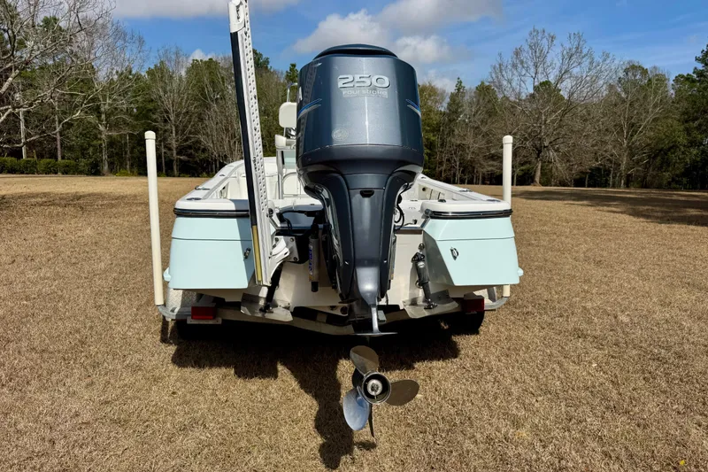 Slide: The Image of 2007 BlackJack 224 boat with 250 horsepower engine on grassy field. - 4