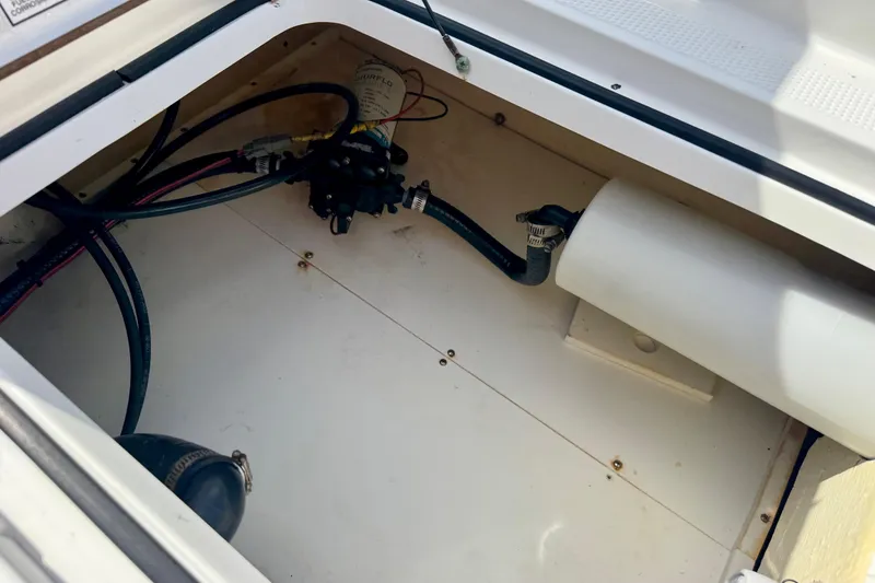Slide: The Image of Open compartment of 2007 BlackJack 224 boat showing internal wiring and components. - 6