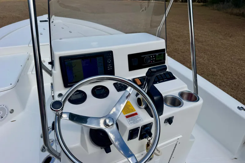 Slide: The Image of Steering console of 2007 BlackJack 224 boat with navigation equipment and controls. - 8