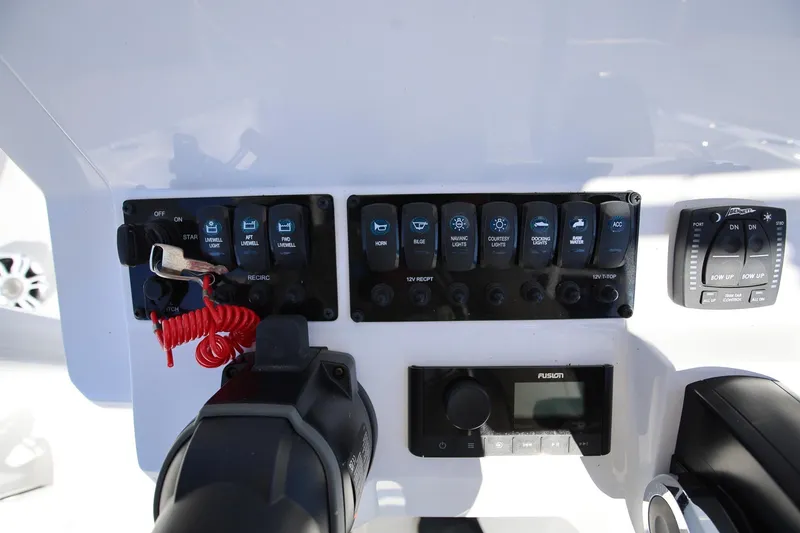 Slide: The Image of Control panel of 2025 Stingray 216 CC boat with switches and gauges. - 11